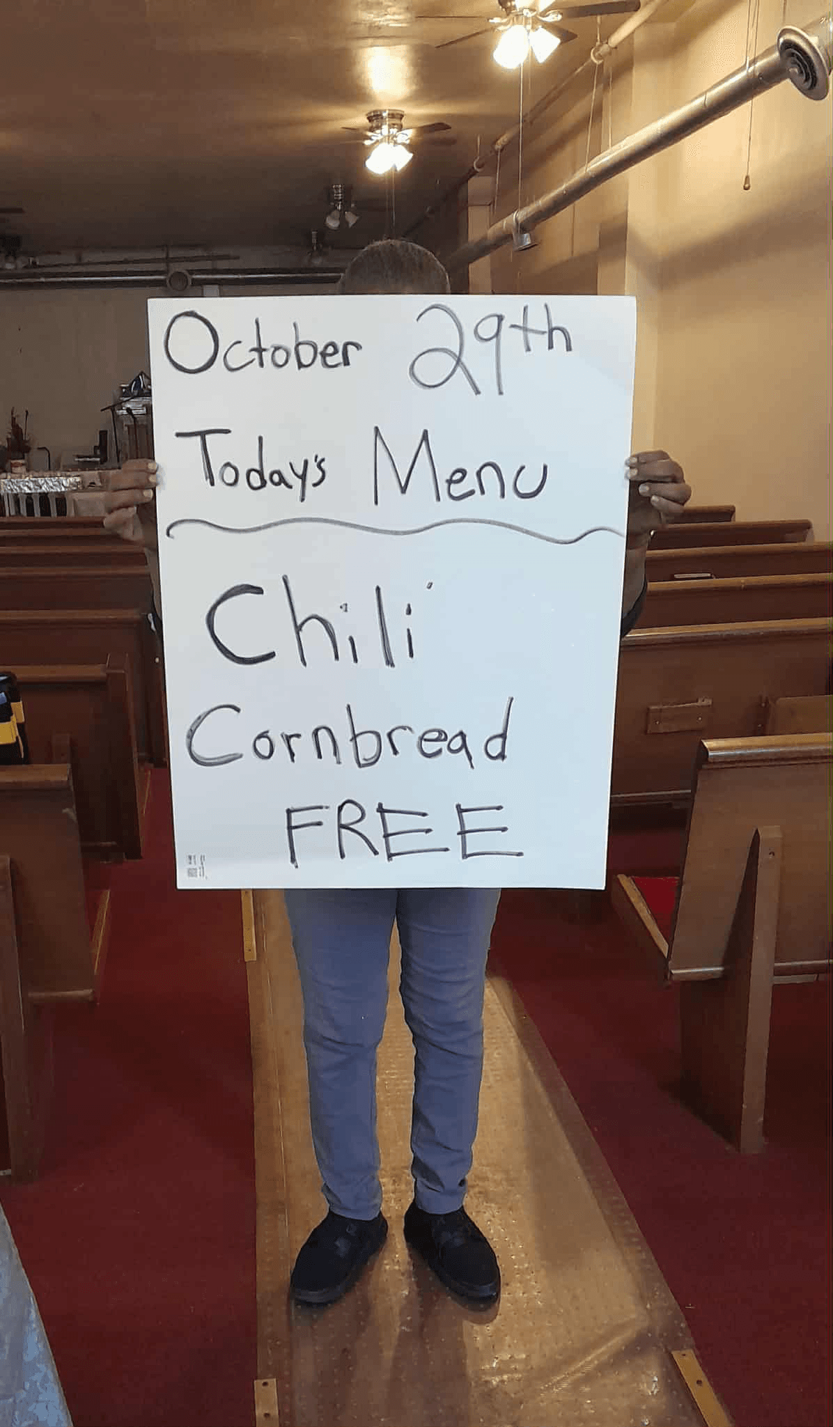 Handwritten menu sign showing free chili and cornbread meal offering dated October 29th